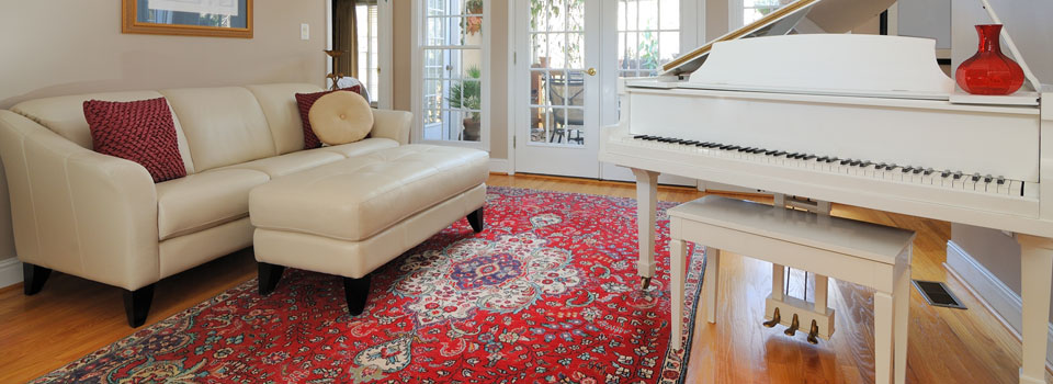 Oriental carpet in room with piano